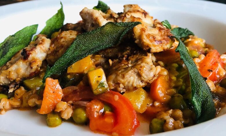 Spelt Risotto tomato vegetables with pan fried pork and